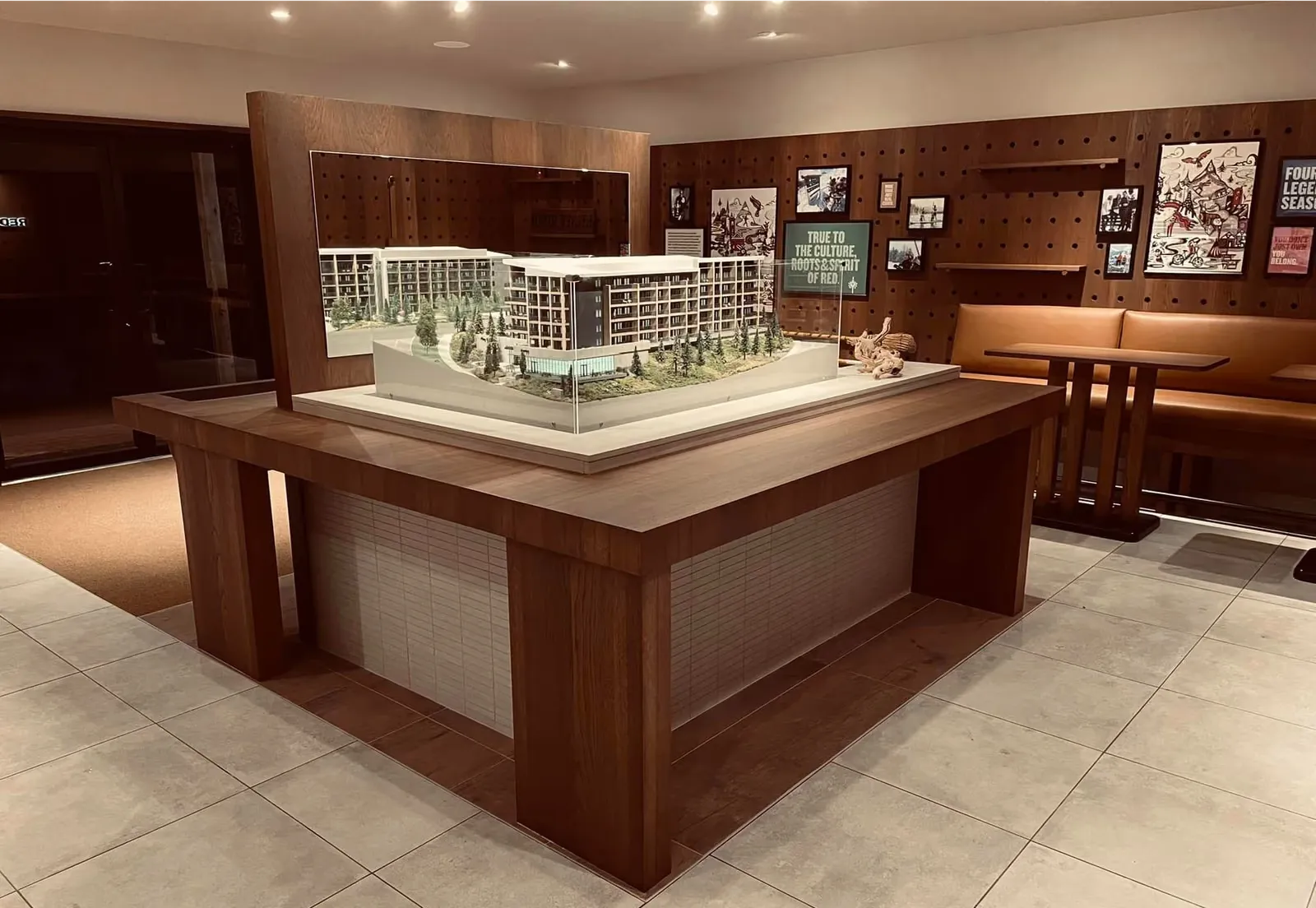 Presentation centre with walnut panelling and a lit architectural scale model