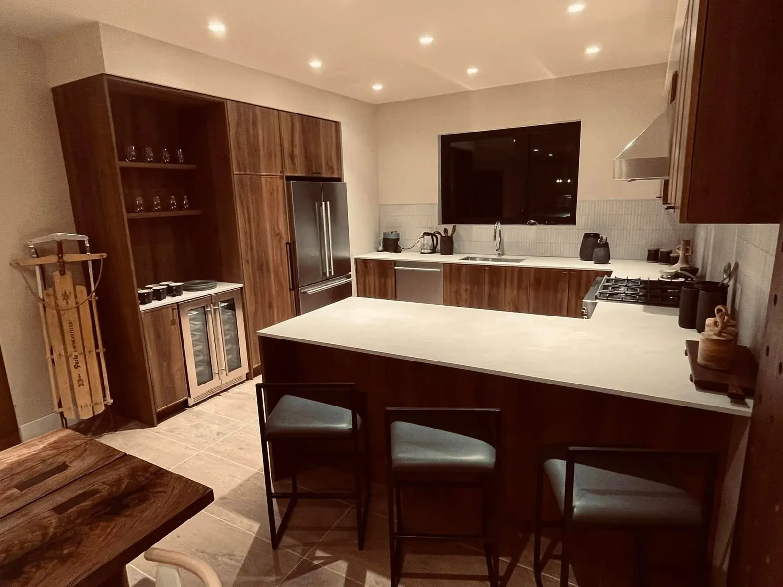 RED Mountain presentation centre display kitchen in walnut with a tall pantry run